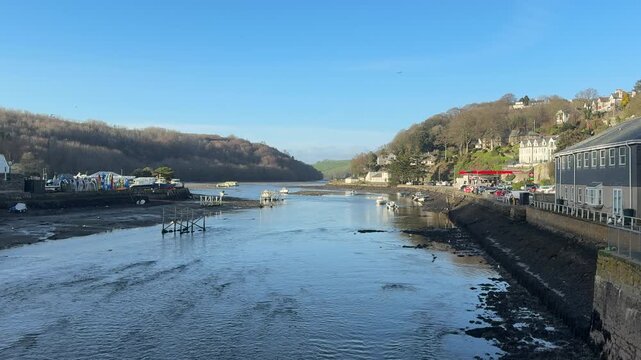 Love seaside town in Cornwall looking down river to tourist area in holiday spot in England UK 4K