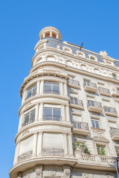 Building Facade with Rounded Windows, Beaux Arts Architecture, Iron Balconies, Mansard Roof, Barcelona