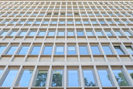 Modern Architecture Facade with Geometric Concrete Window Grid Pattern, Abstract Building Exterior, Symmetric Lines