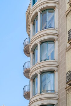Classical Building Facade with Curved Windows, Rounded Glass Balconies, Architecture, Ornate Columns, Corner View