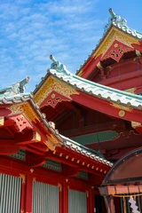 Traditional Japanese temple architecture against a blue sky © Cavan