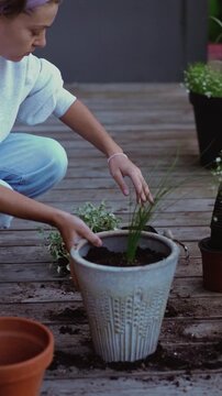 Young woman enjoys container gardening on a patio