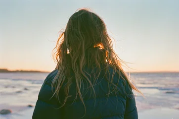 Child in puffer jacket enjoying a winter sunset © Cavan