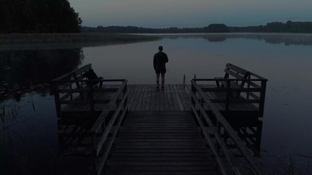 silhouette of a man on a pier