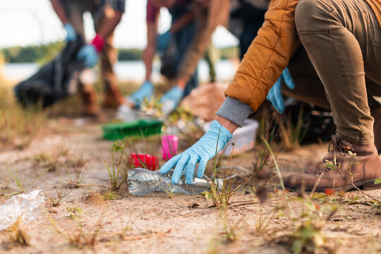 Volunteers collecting plastic waste from polluted nature area