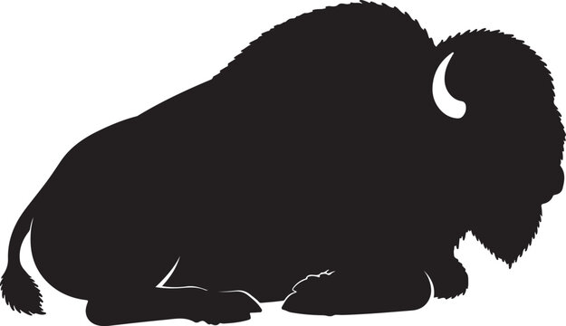 Black silhouette of a bison lying down