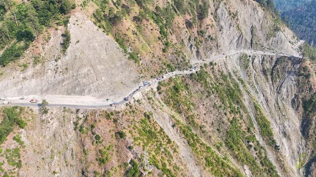 Aerial view of traffic congestion on dangerous Himalayan mountain road.