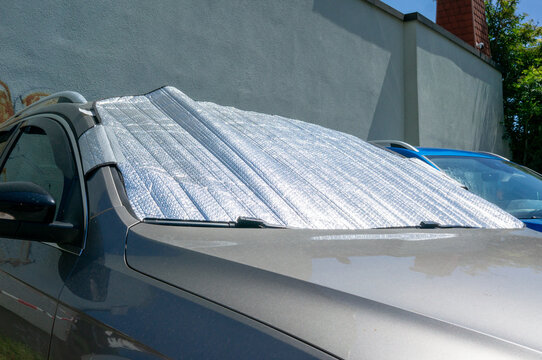 Sunshade insulation mat on car windshield during hot summer weather