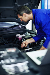 Man, mechanic and inspection at car for maintenance, engine diagnostics and repair service in garage. Employee, tools and vehicle in workshop for fixing, calibration and mechanical evaluation © peopleimages.com
