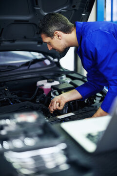 Man, mechanic and inspection at car for maintenance, engine diagnostics and repair service in garage. Employee, tools and vehicle in workshop for fixing, calibration and mechanical evaluation