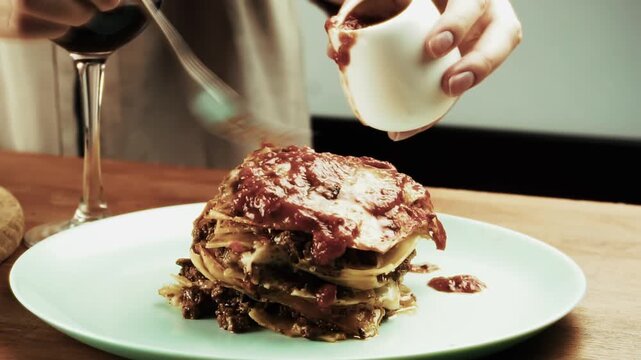 Pouring Tomato Bolognese Sauce On Freshly Baked Hot Lasagna. Italian Pasta Dish