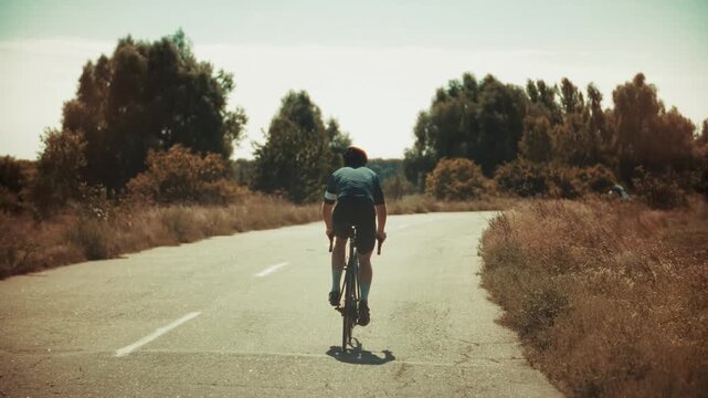 Riding Road Bicycle On Asphalt Countryside Highway. Athlete Preparing For Competition