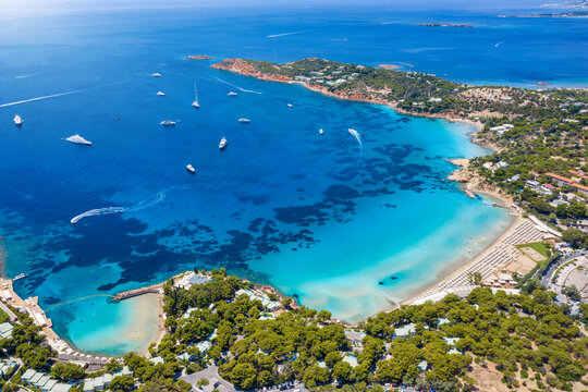 Aerial view of the popular Astir Beach in Vouliagmeni, south Athens coast, Greece, with turquoise sea and moored luxury yachts during summer time