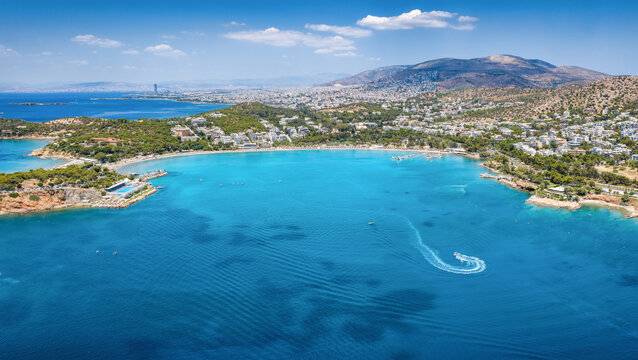Panoramic aerial view of the bay and beach of Vouliagmeni, south coast of Athens, Greece, with turquoise sea during summer time