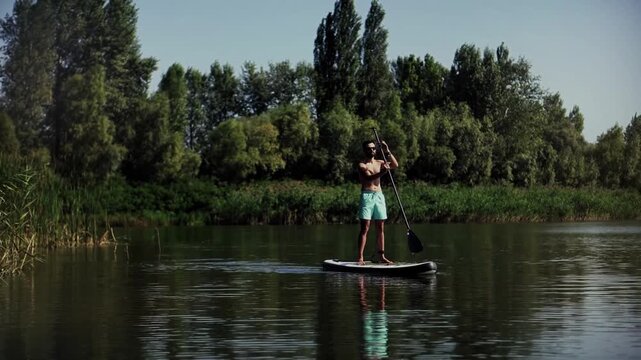 Paddleboarder Rowing On Stand Up Paddle Board On Calm River. Water Sports