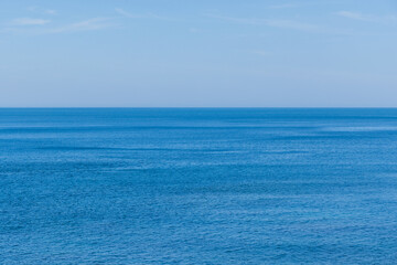 Calm blue sea water under clear sky © leungchopan