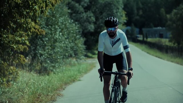 Cyclist Riding Road Bicycle On Asphalt Highway.  Active Sportsman Cycling Speed Workout Training. Summer Outdoor Race 