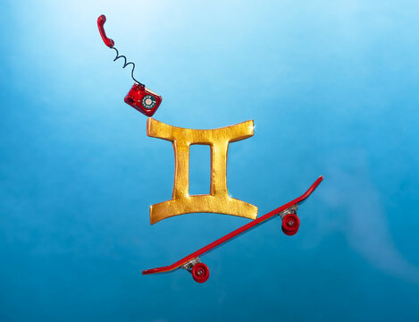 Gemini astrology symbol balancing on skateboard with telephone