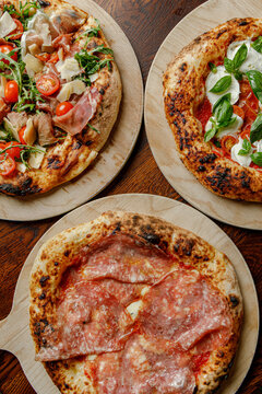 Prepared craft pizzas with various toppings in an authentic pizzeria