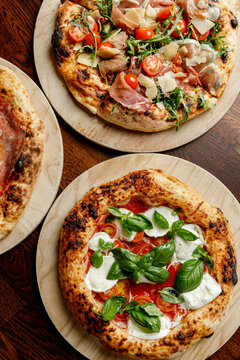 Prepared craft pizzas with various toppings in an authentic pizzeria