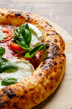 Craft pizza with mozzarella, basil and tomatoes isolated.