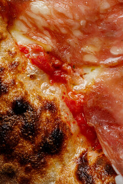 Texture of pizza with ham salami prosciutto close-up