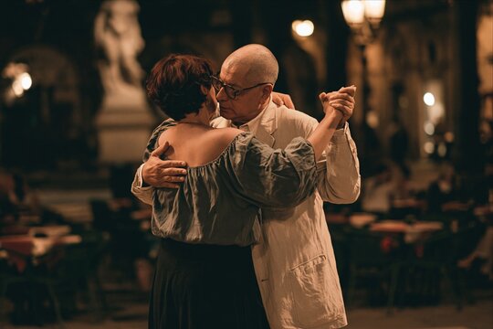 Senior couple dancing intimately tango at night