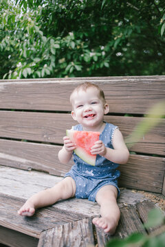 Baby/toddler eating outside in summer