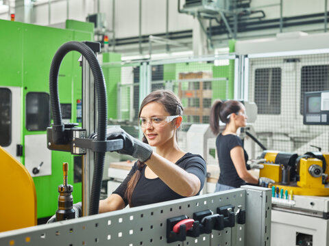 Two women working on machines