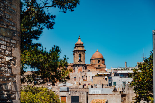 Church dome and bell tower rising above Erice rooftops in Sicily