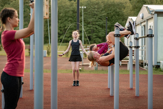 Women and girls exercising together at an outdoor gym