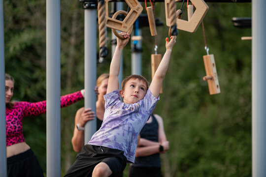 Determined young boy navigates a climbing frame