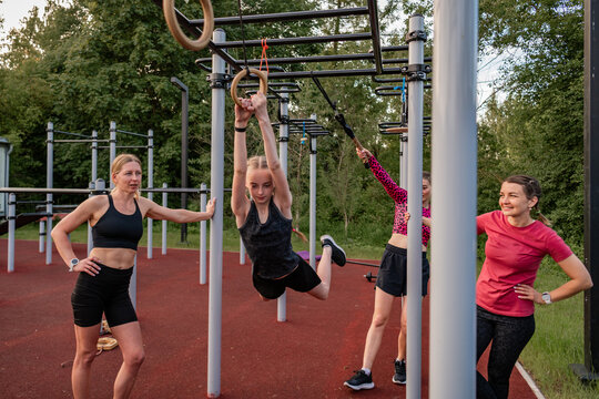 Group of women work out at a calisthenics park
