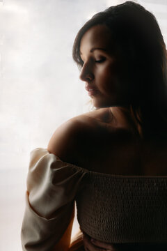 Serene woman with closed eyes in soft light