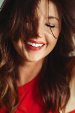 Joyful woman with beautiful smile and messy hair