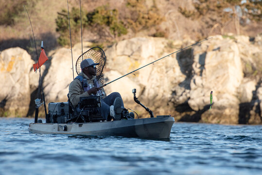 Black man enjoying a day of kayak fishing