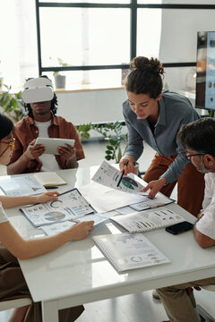 Colleagues brainstorming with VR technology in a modern office meeting