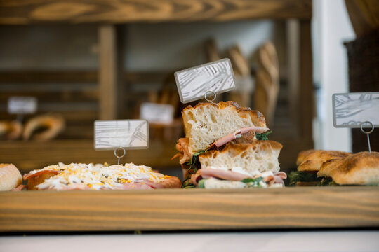 Artisan sandwiches and bread displayed at bakery shop counter