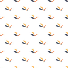 Fototapeta premium Hand flipping a pancake in a frying pan creating a seamless repeated pattern