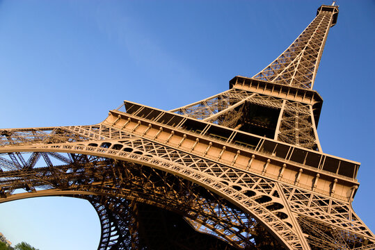 Low angle view of the Eiffel Tower in Paris against a blue sky