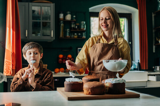 Mother and son baking Easter bread together in a warm kitchen