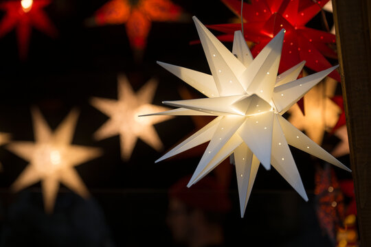 Illuminated white paper star lantern at a Christmas market