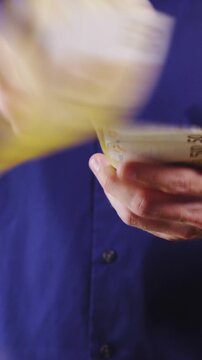 Throwing money in camera lens close up