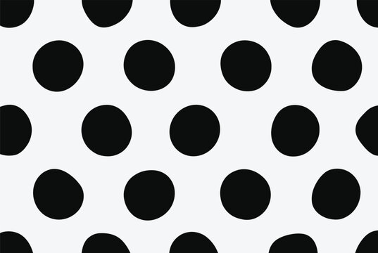 Abstract pattern of large irregular black polka dots on a white background for modern and bold textile designs.
