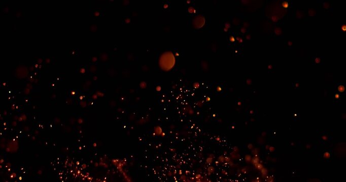 Ultra slow motion floating embers and glowing sparks on black background captured at 1000 FPS. Atmospheric fire particles drifting through darkness, ideal for cinematic overlays.