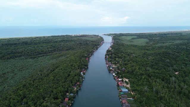 Cinematic aerial view of rustic wooden river houses and traditional fishing huts on Ada Bojana, Montenegro