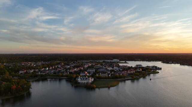 Aerial view of luxury houses in Houston, Woodlands by the lake with dramatic sky by sunset in Texas, United States