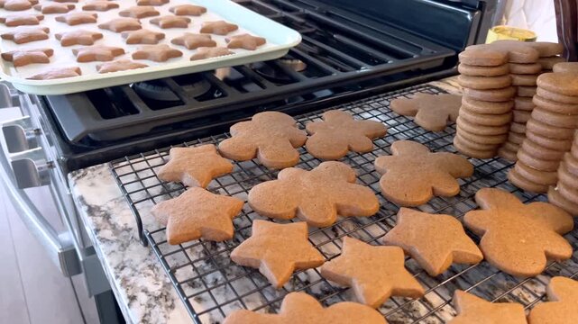 Baking tray of cookies resting on stovetop edge in kitchen