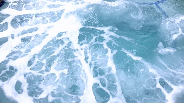 Frothy bubbles on water in circular hot tub
