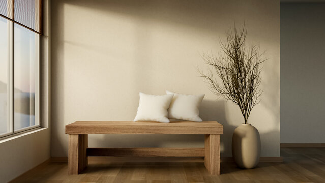 Minimalist wooden bench with decorative vase and dried branches in warm sunlit interior